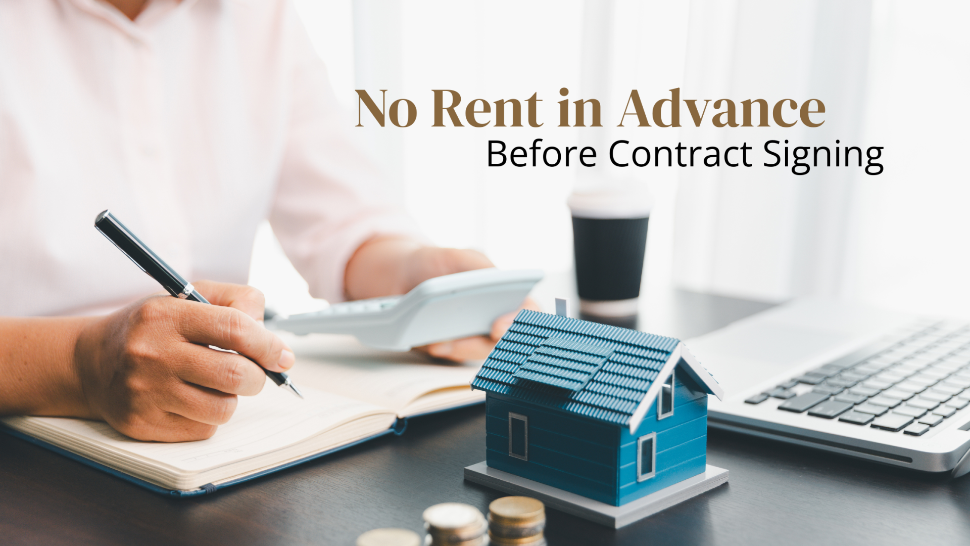 Hands holding calculator, a model house on desk