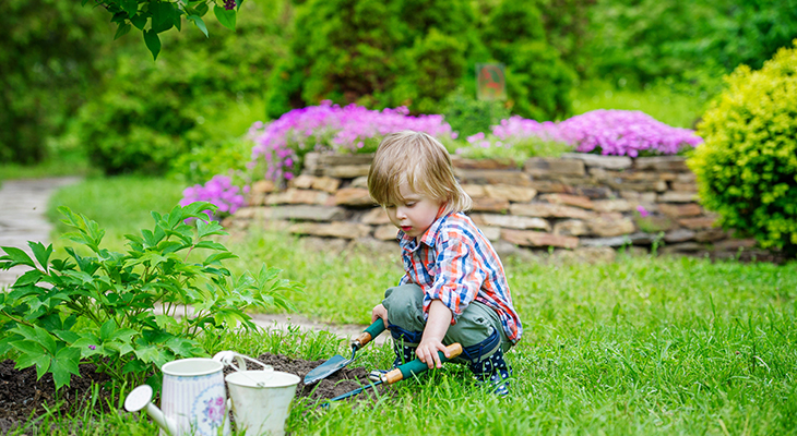 child_son_playing_garden_bucket_trowel_gardening