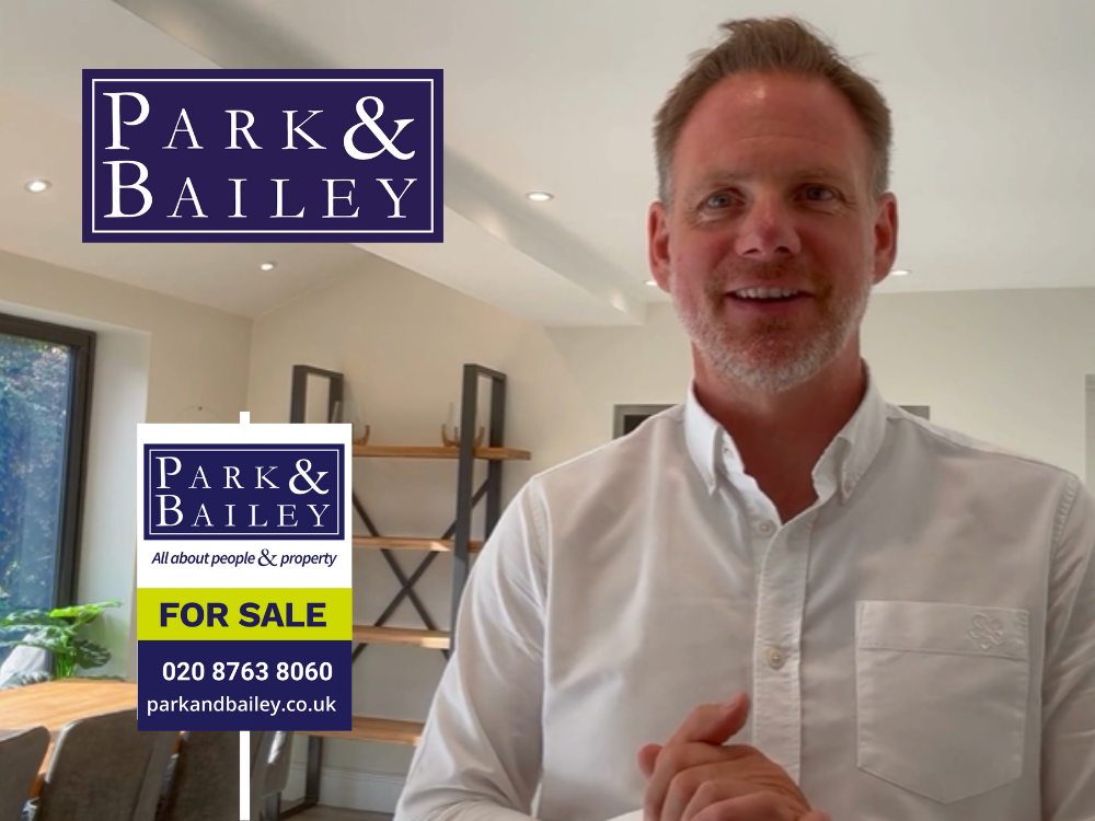 Estate Agent with graphic of a Park & Bailey Board