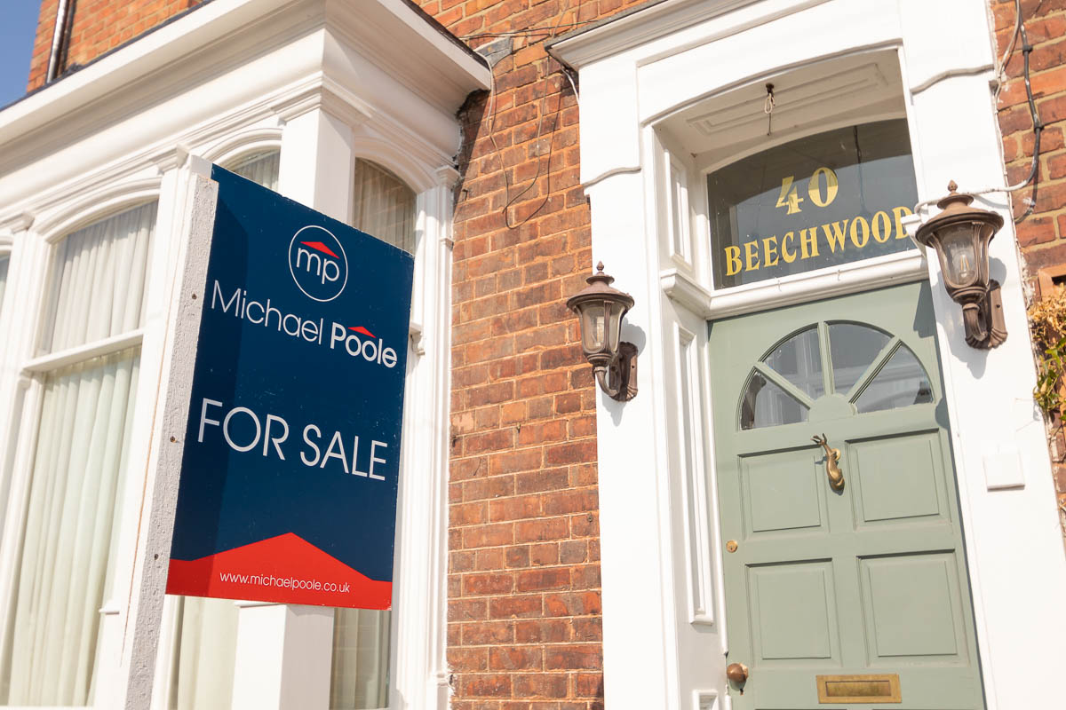 House with a for sale sign