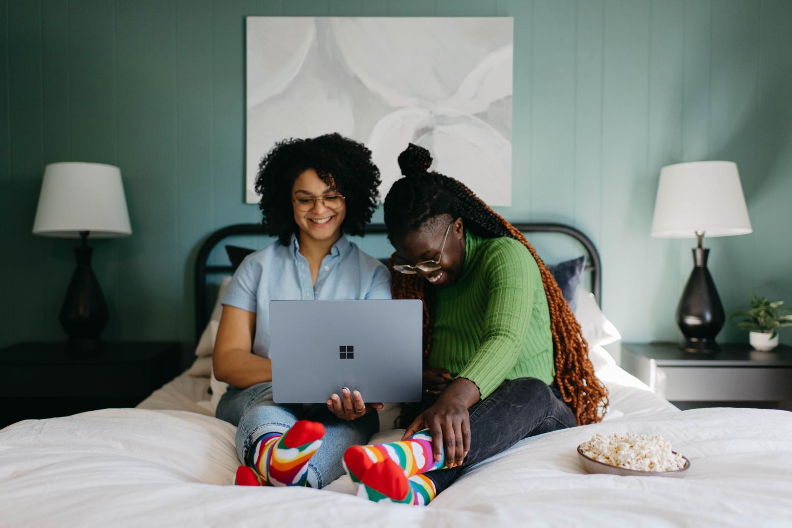 Young couple smiling at laptop