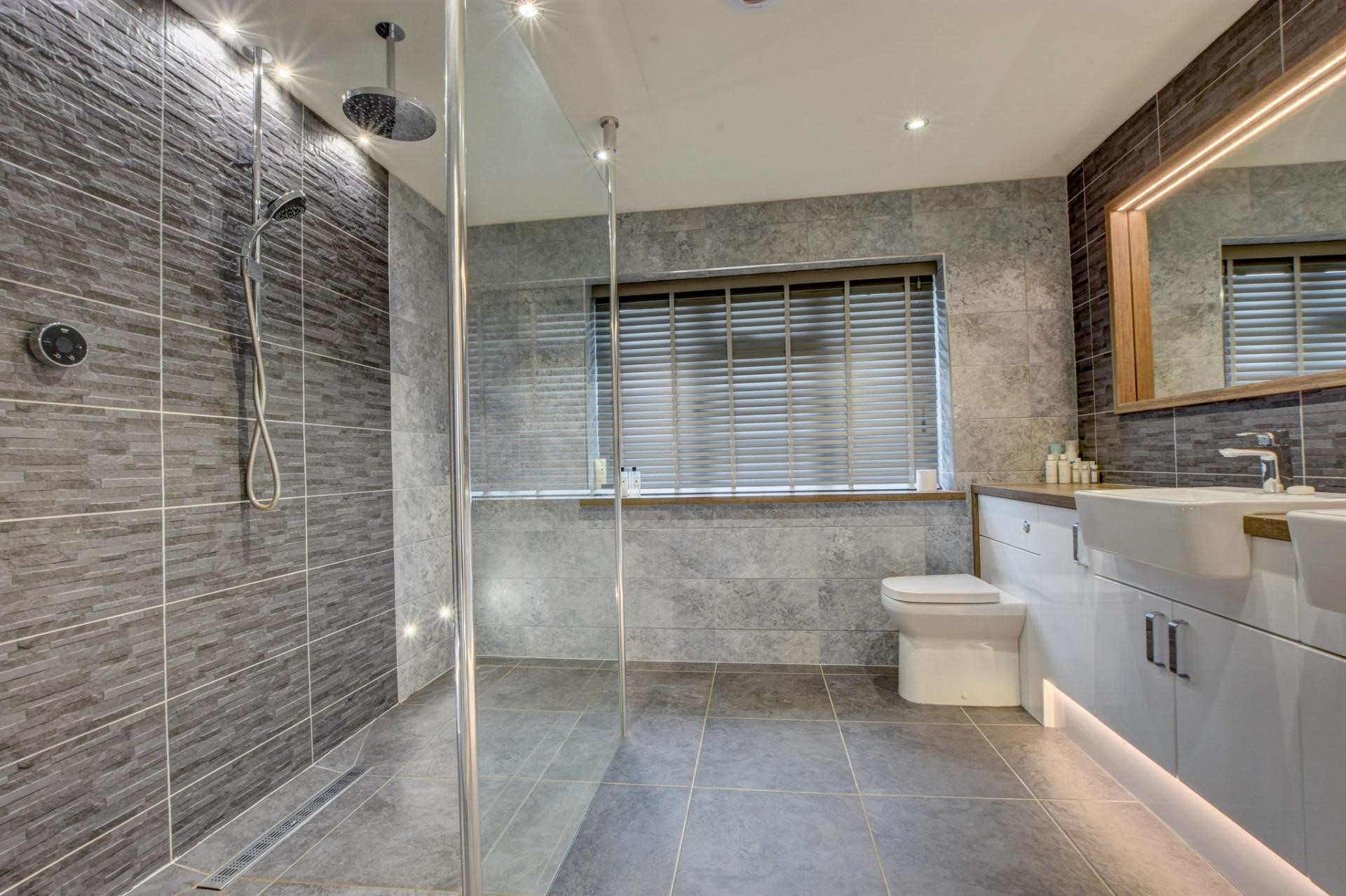 modern contemporary luxury bathroom grey tiles accent lighting