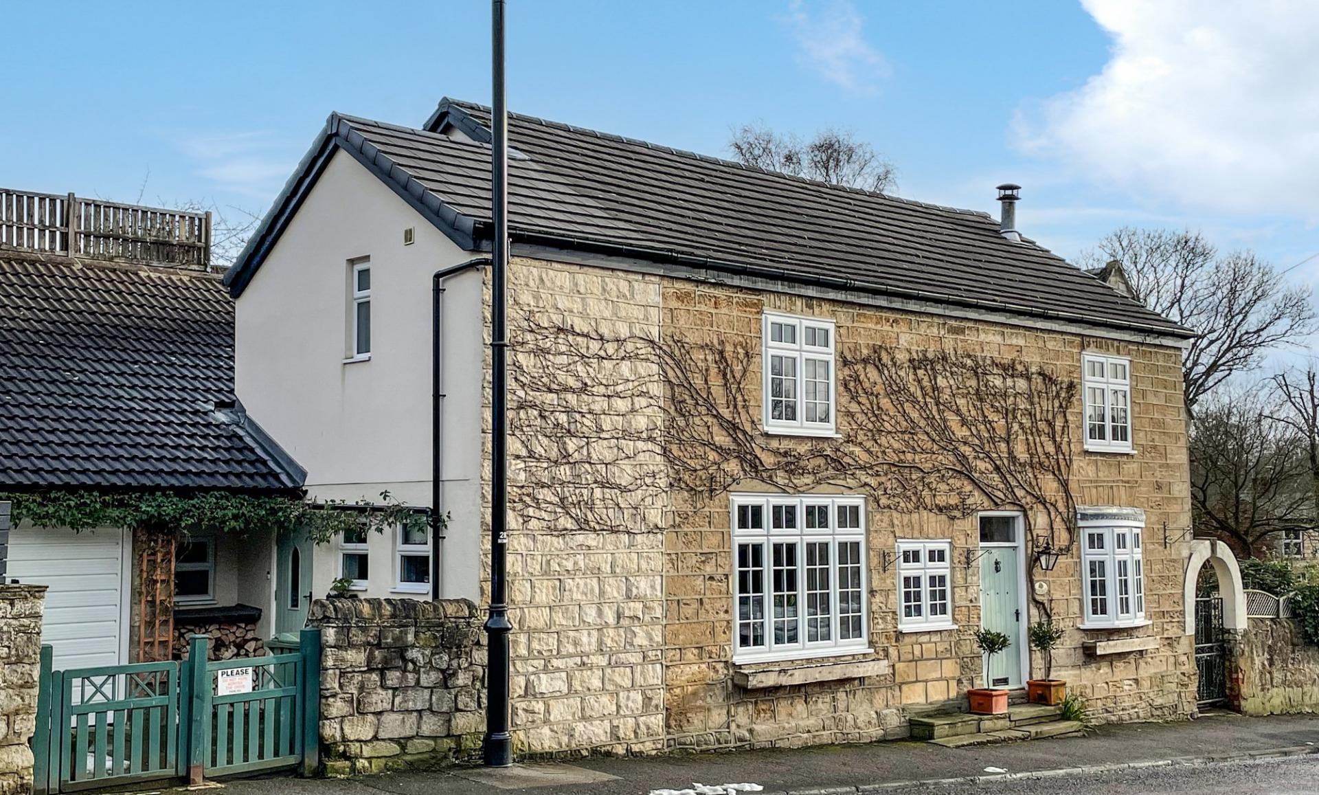 West Yorkshire stone built charming village cottage with blue door.