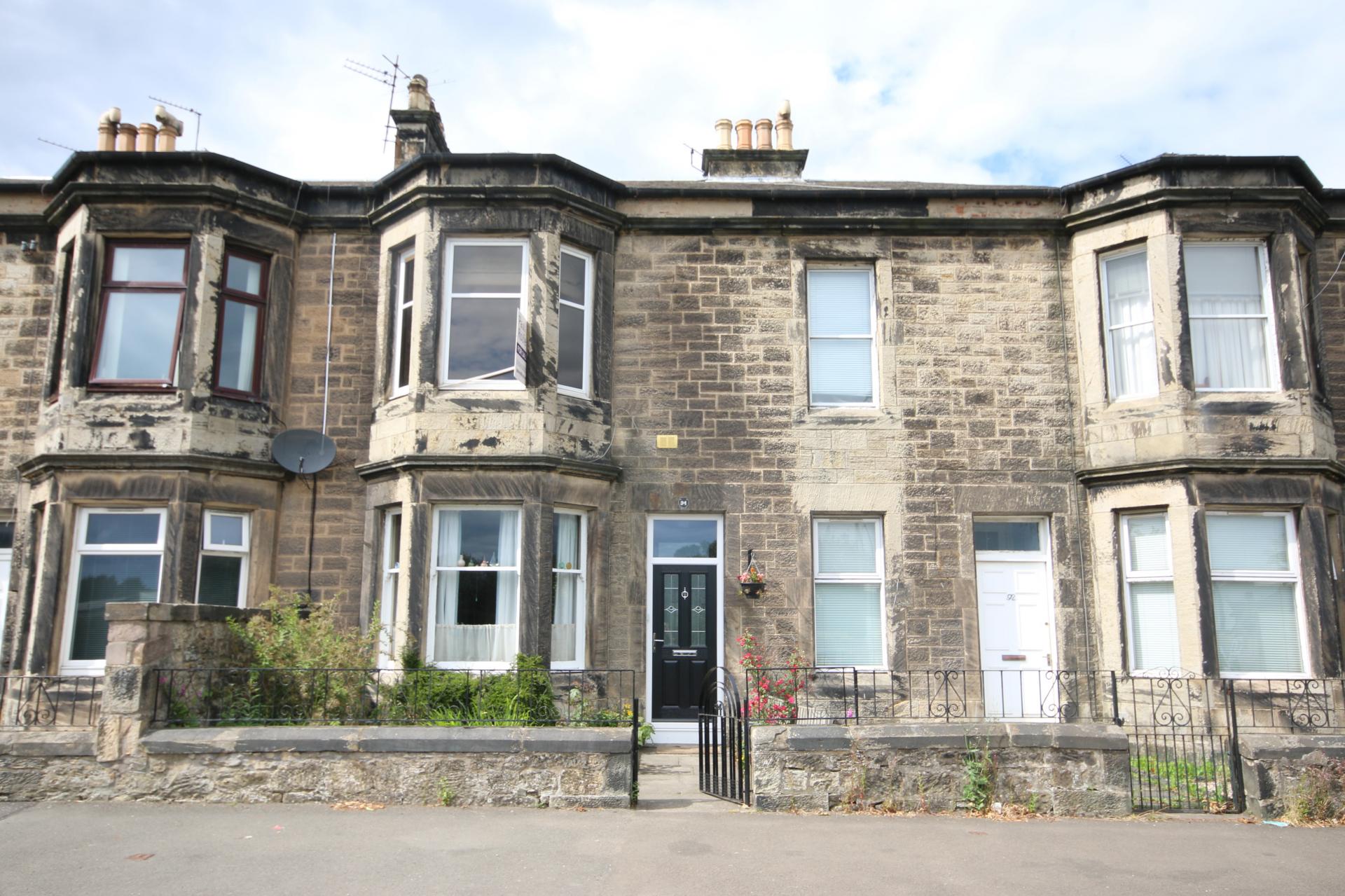 traditional grey sandstone Victorian terraced house with bay window Scotland