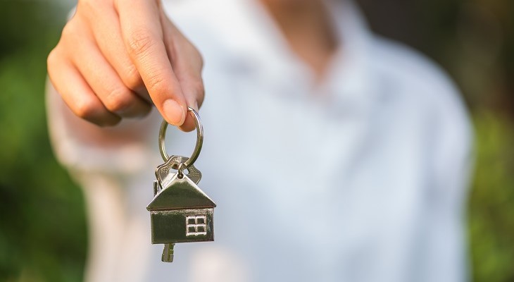 real estate agent keys to new house for buyer